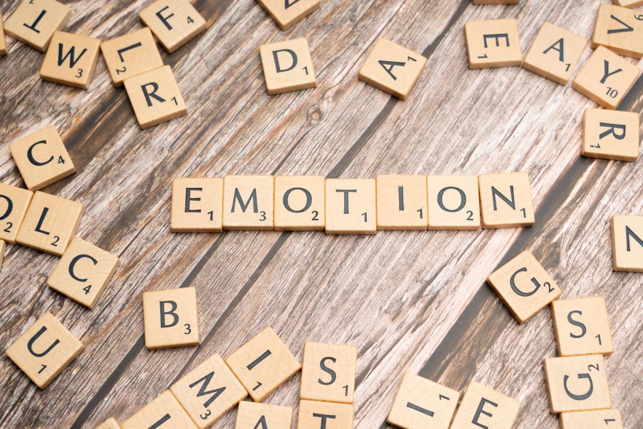 Crafting Captivating Headlines: Your awesome post title goes here Scrabble tiles forming the word emotion on a wooden background.